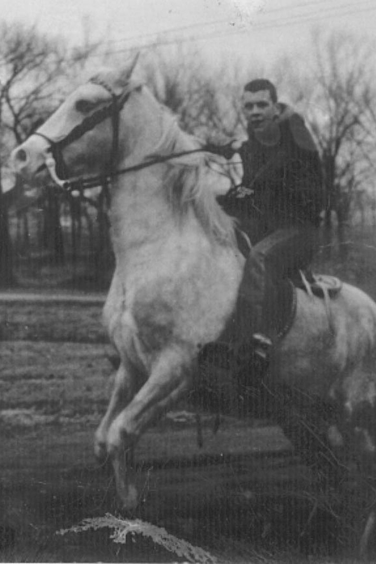 Riding his trick-horse, Silver.